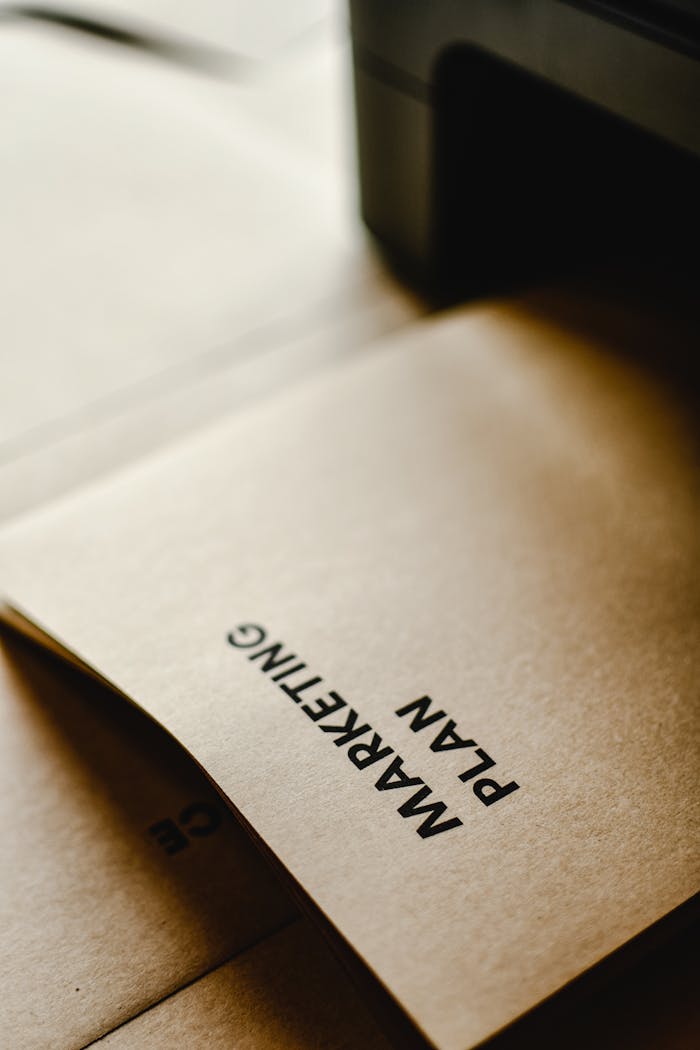 The Art of Drawing Readers In: Your attractive post title goes here Detailed view of the words 'Marketing Plan' printed on brown paper, conceptual and business themed.