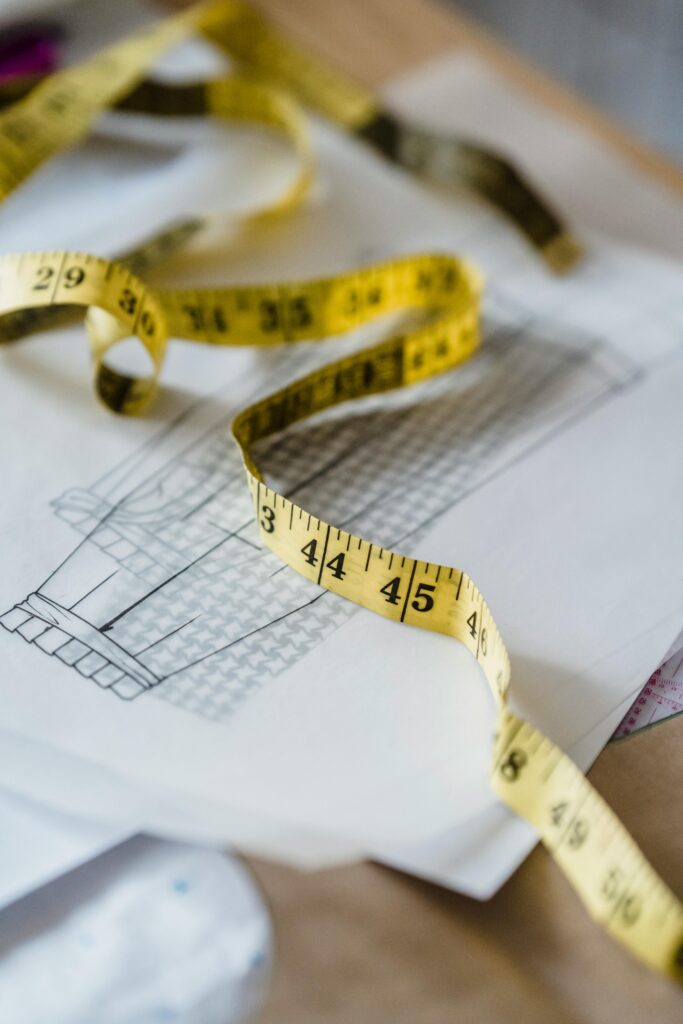 Detailed view of measuring tape on architectural plans for design projects.